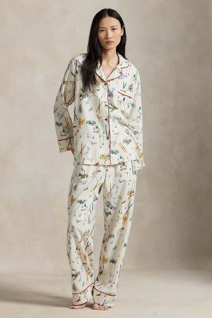 Woman wearing a ski pajama set against a neutral background