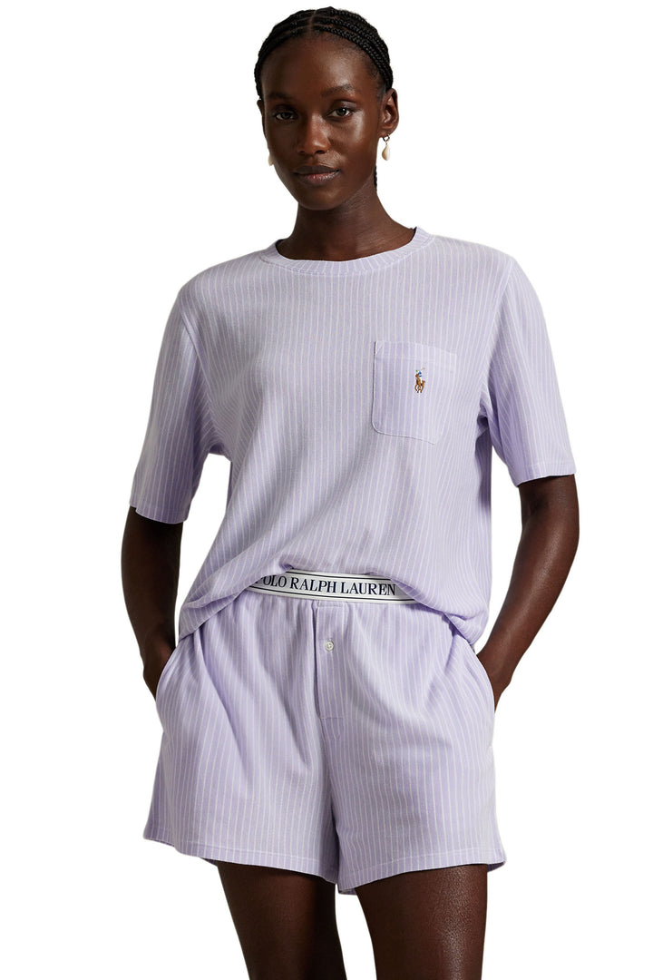 Woman wearing a matching purple striped outfit with Ralph Lauren logo on a white background