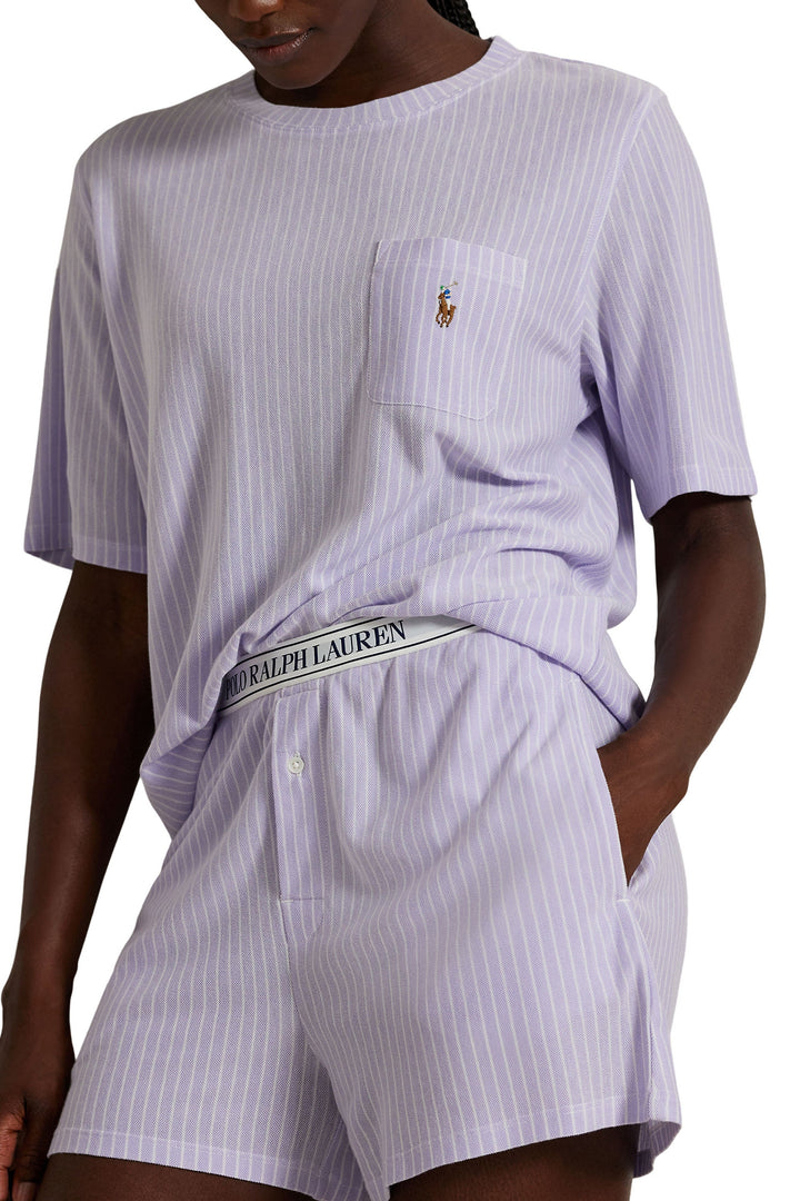 Person wearing a Ralph Lauren outfit with a striped shirt and shorts on a white background
