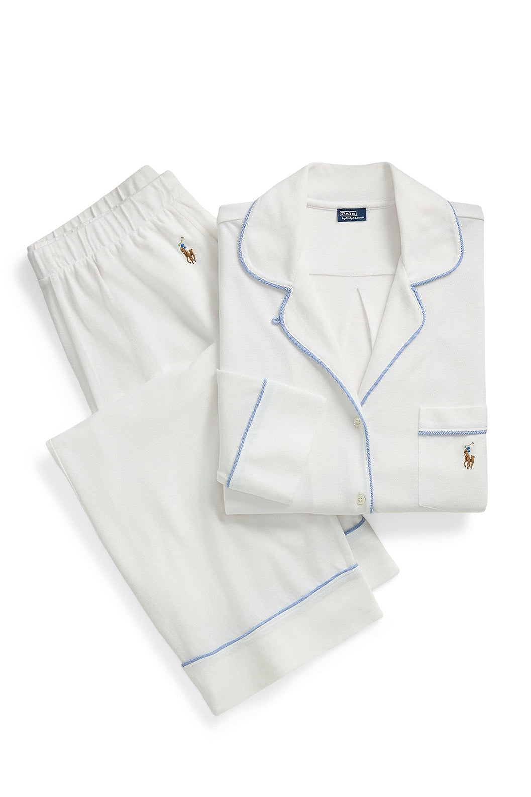 A folded white pajama set with light blue piping and small embroidered polo player logos, shown on a clean white background.