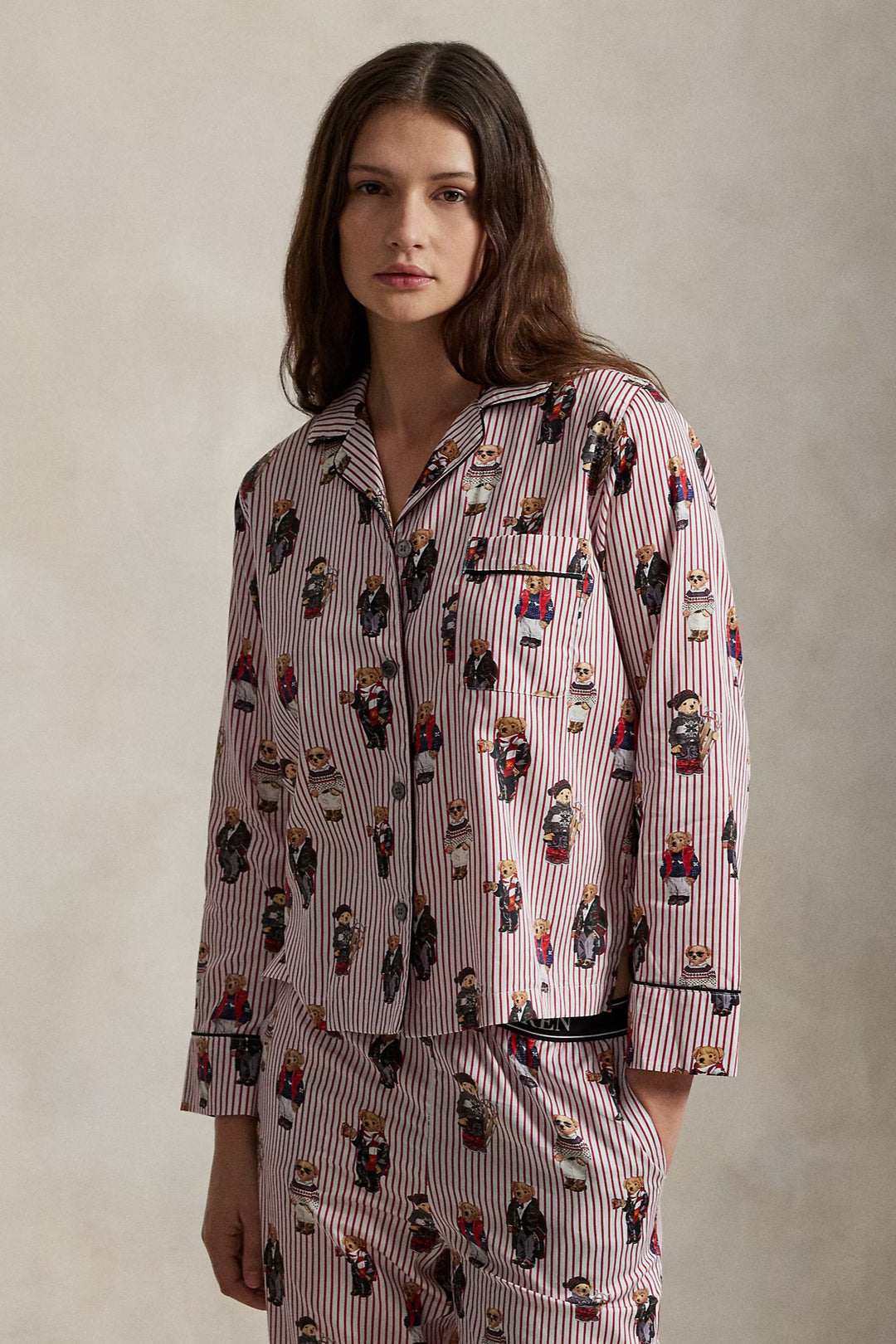 Woman wearing a patterned pajama set against a neutral background