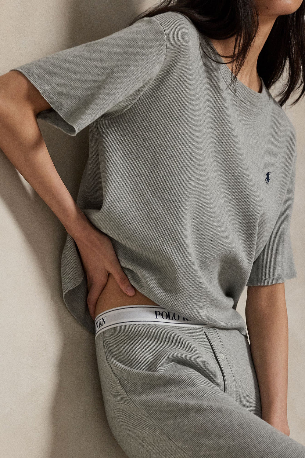 model wearing waffle knit grey heather relaxed-fit short sleeve tee with wide leg pant featuring Polo Ralph Lauren elastic waistband. 