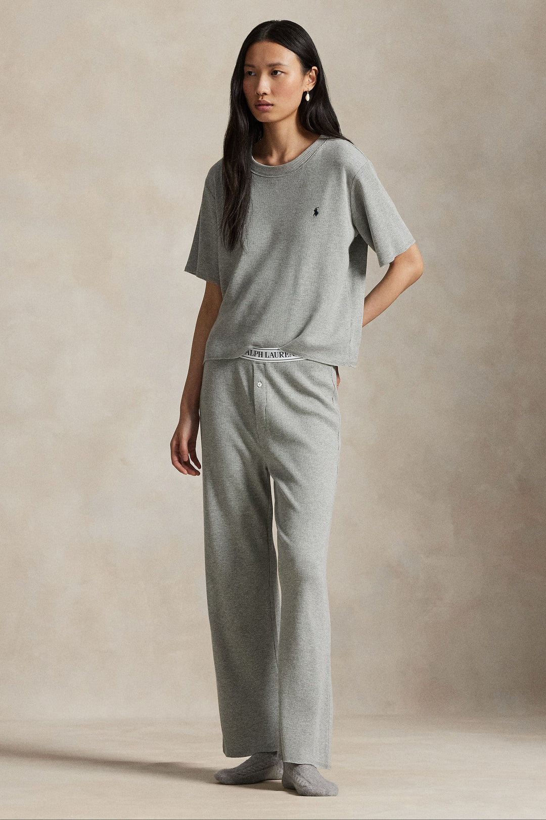 model wearing waffle knit grey heather relaxed-fit short sleeve tee with wide leg pant featuring Polo Ralph Lauren elastic waistband. 