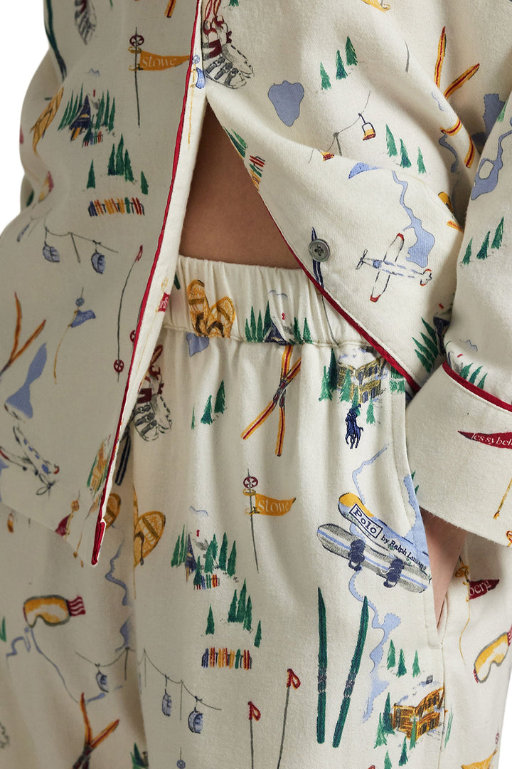 Pajama set with a colorful pattern of skis, trees, and flags on a white background.