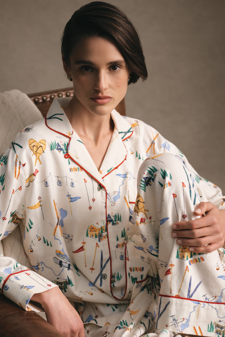 Person wearing a colorful pajama set sitting on a couch.