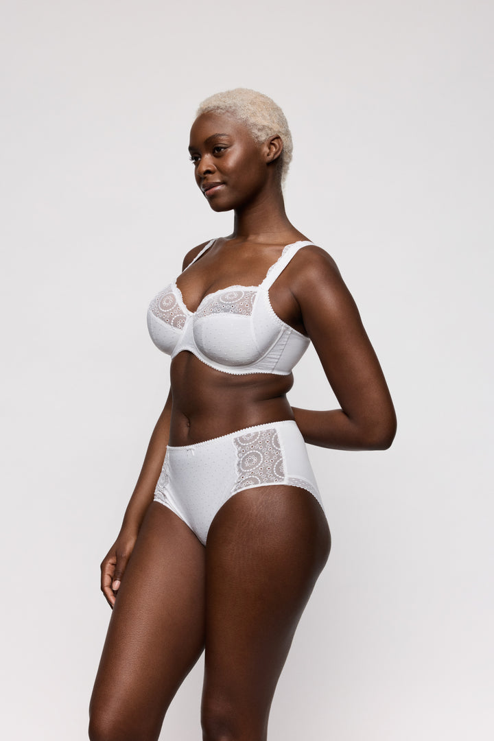 Woman wearing a white bra and panties set on a light gray background. Full coverage everyday high briefs.