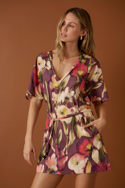 woman wearing Shan floral printed magnolia coverup tunic. Effortless and flowy silhouette with light airy feel. Adjustable belt for cinching and short sleeves for easy wear. 