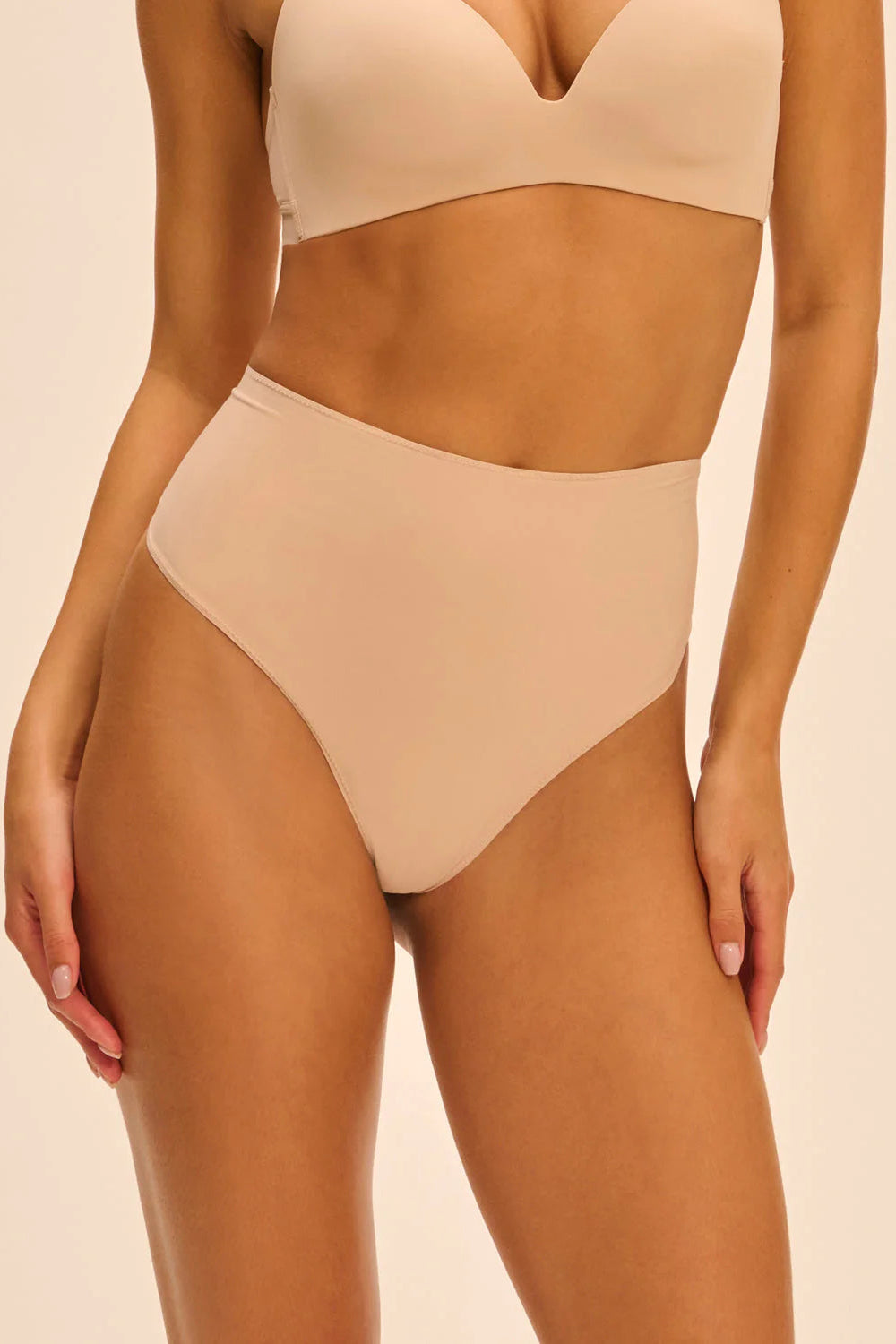 Beige shapewear set on a beige background