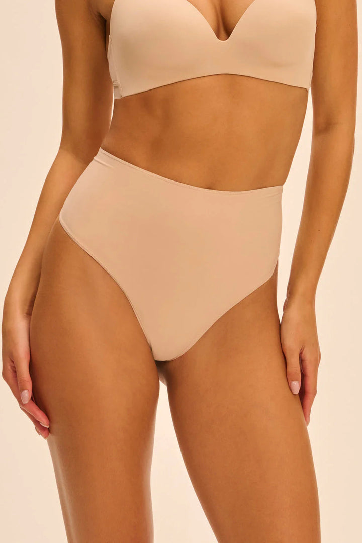 Beige shapewear set on a beige background