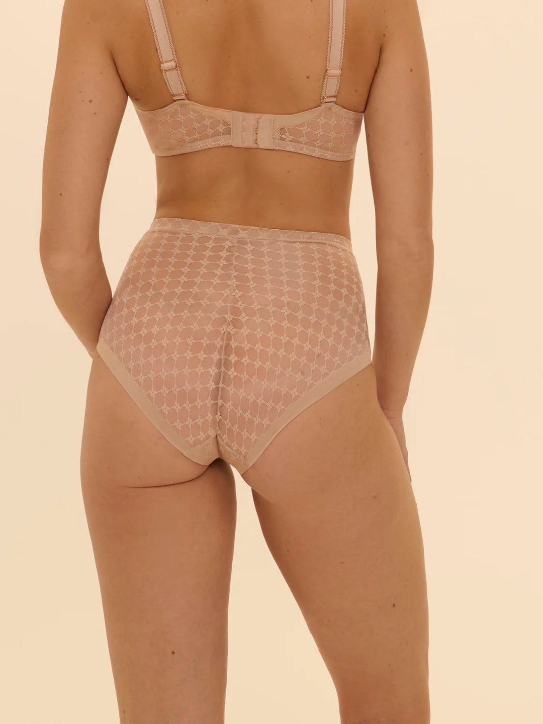 Beige shapewear set on a beige background