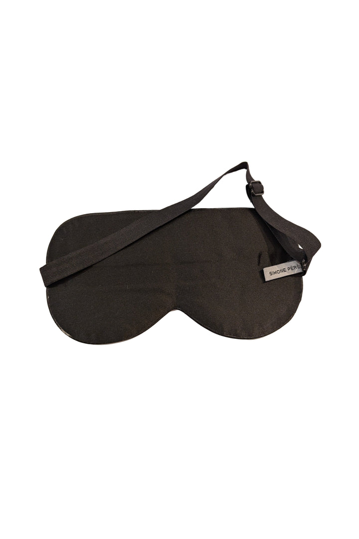 Black sleep mask back on a beige background