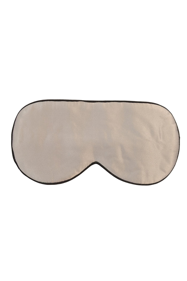 Silk sleep mask on a beige background