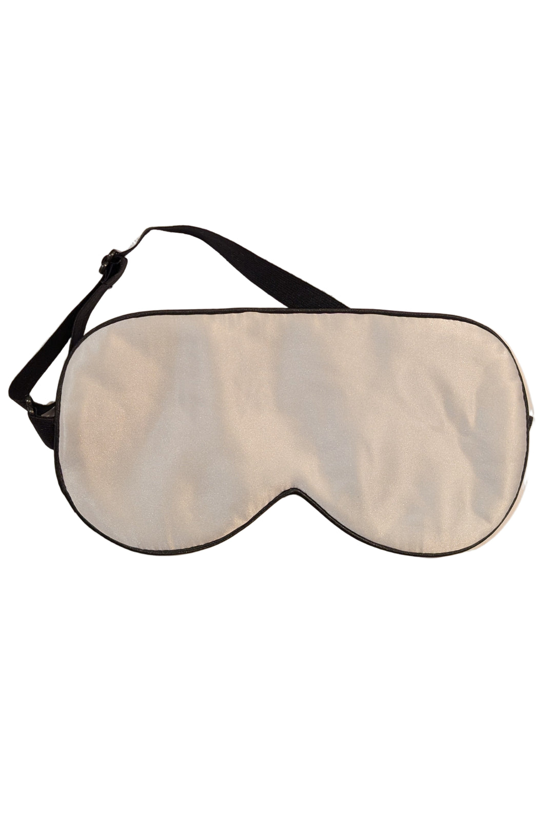 Sleep mask with black strap on a beige background