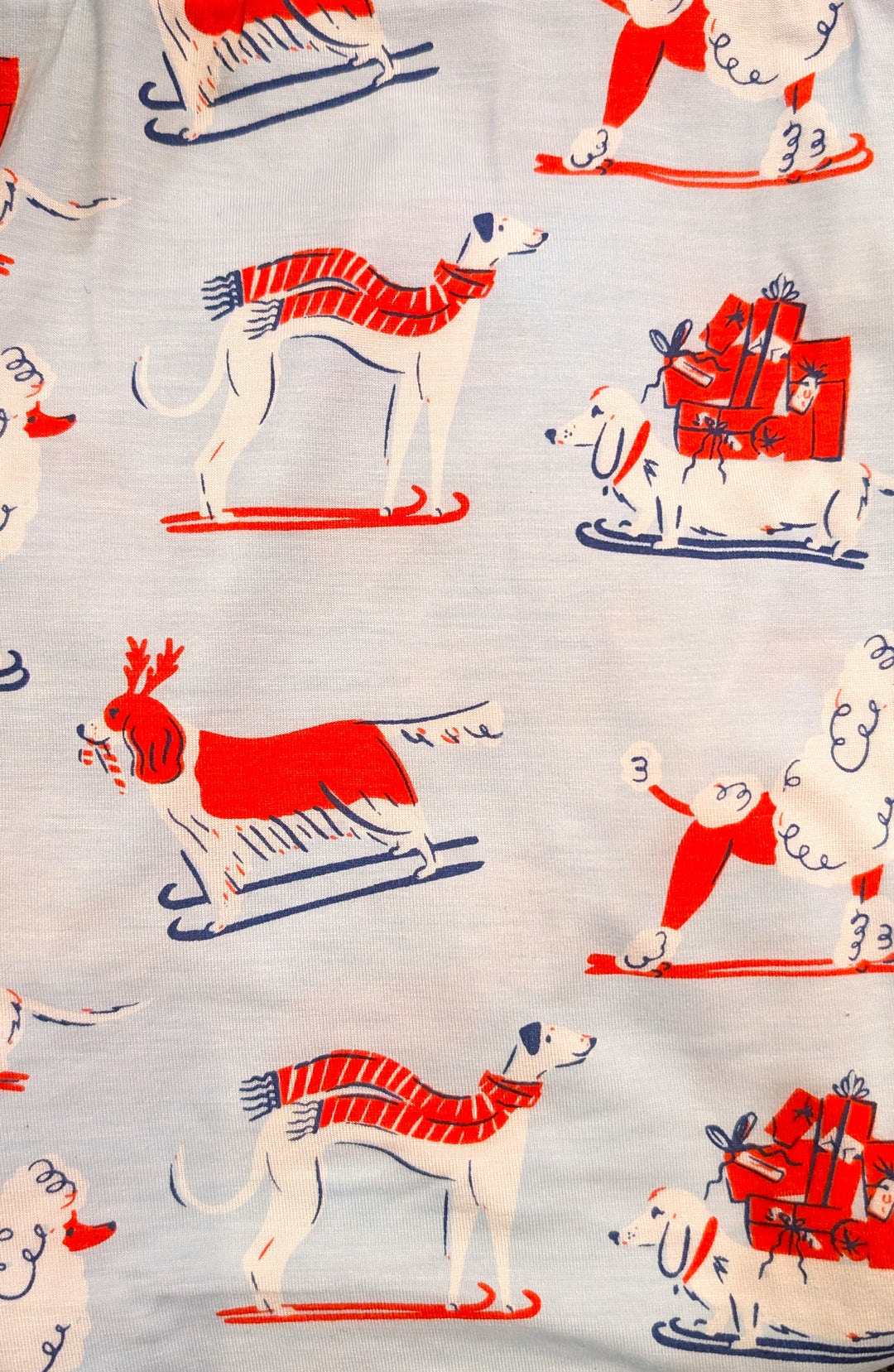 Pattern of dogs in winter attire on a fabric background