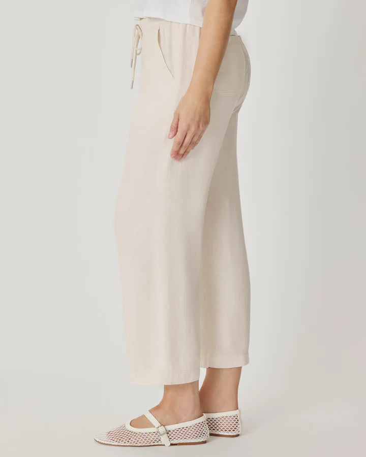 Beige pants with a drawstring on a plain background