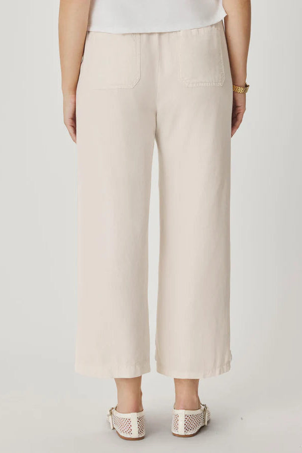 Person wearing beige pants on a plain background